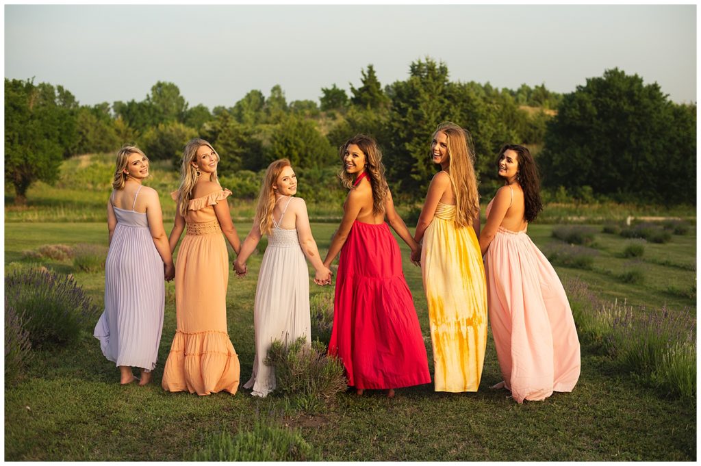 High School Senior girls in flowy dresses in lavender field