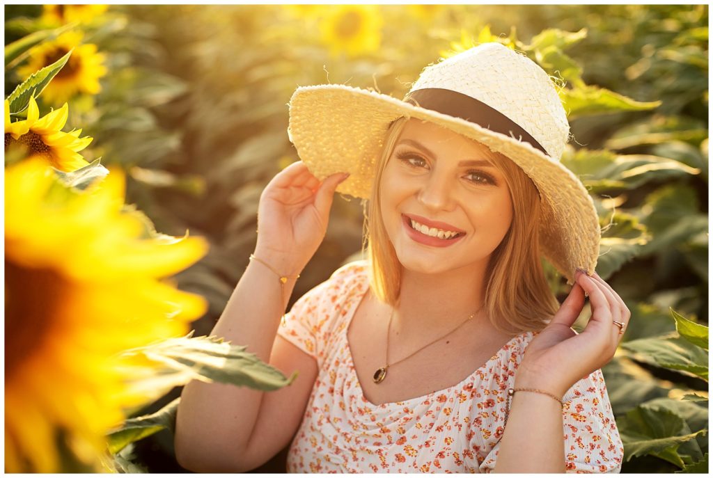 senior girl in hat kansas sunflower field