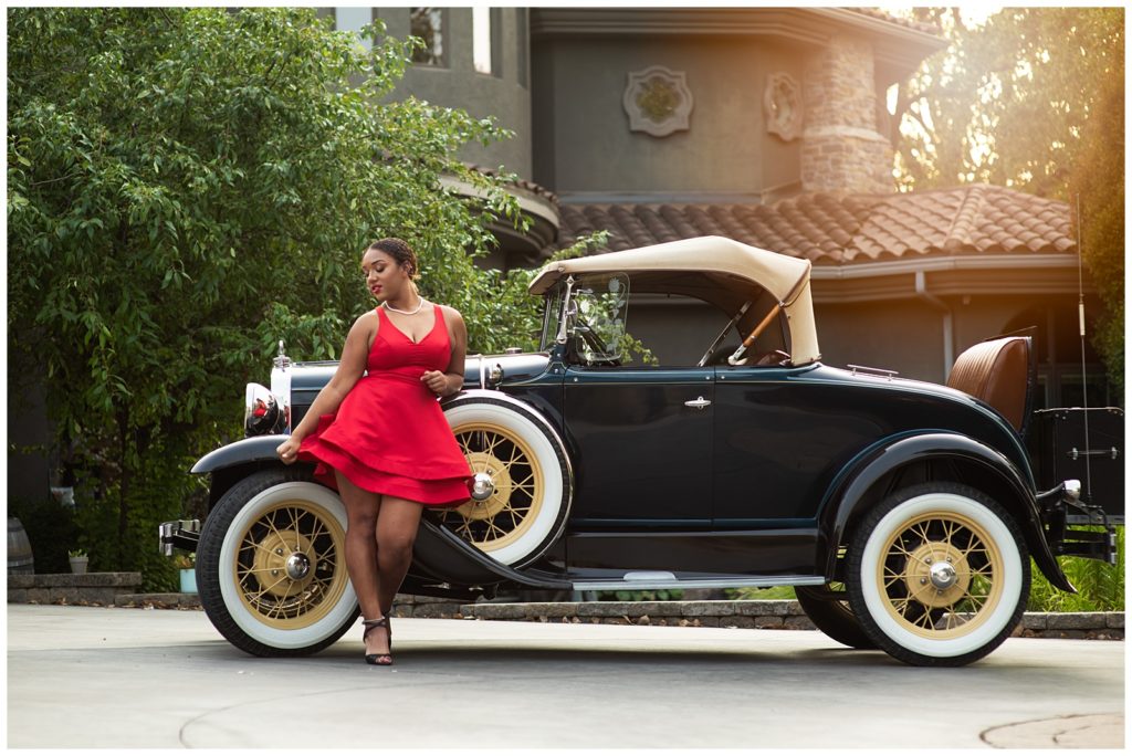 girl in red dress with vintage car