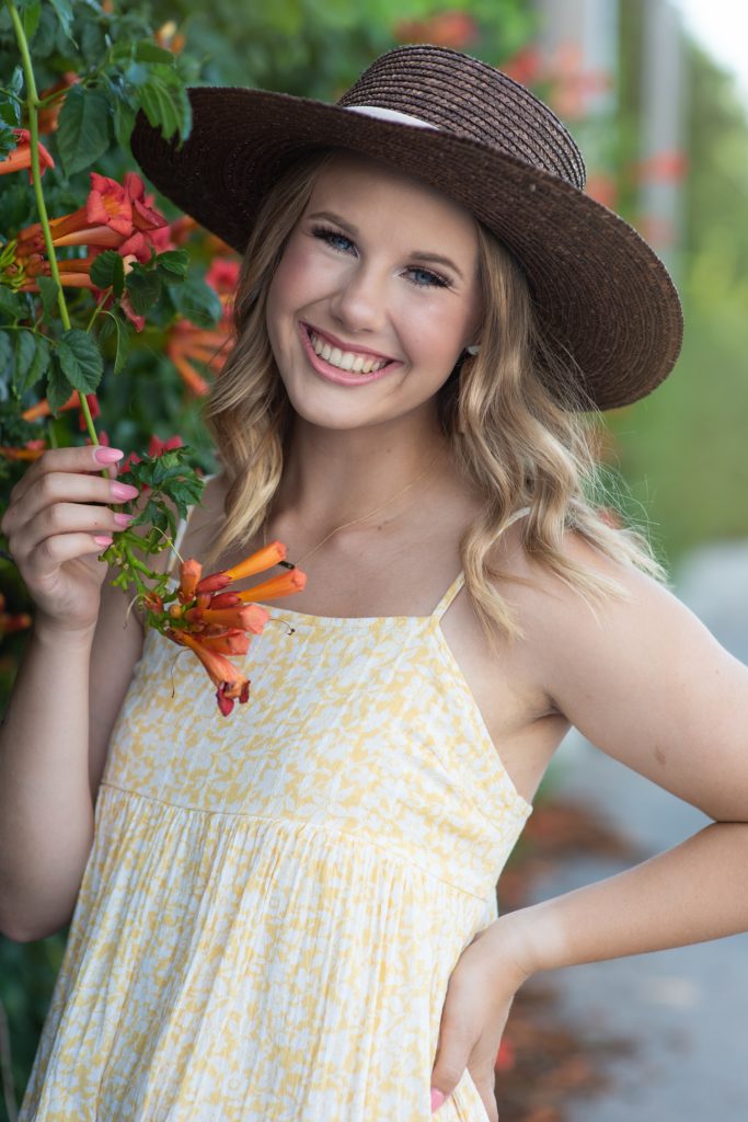 high school senior girl in. brown hat and yellow dress senior pictures