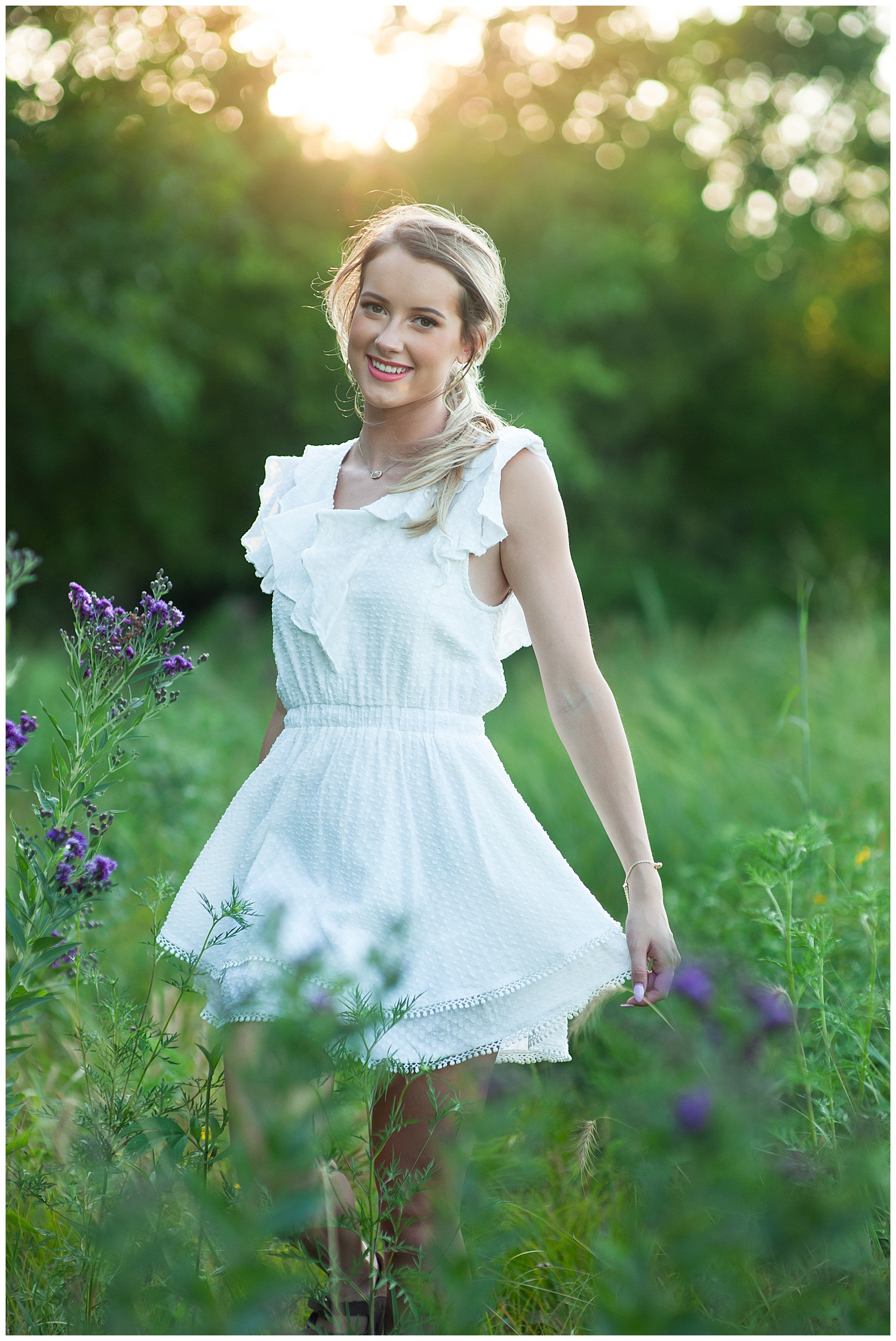 high school senior girl in white dress in field senior. pictures Kim Stiffler Photography