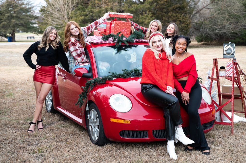 Christmas photoshoot with high school seniors and red vw bug