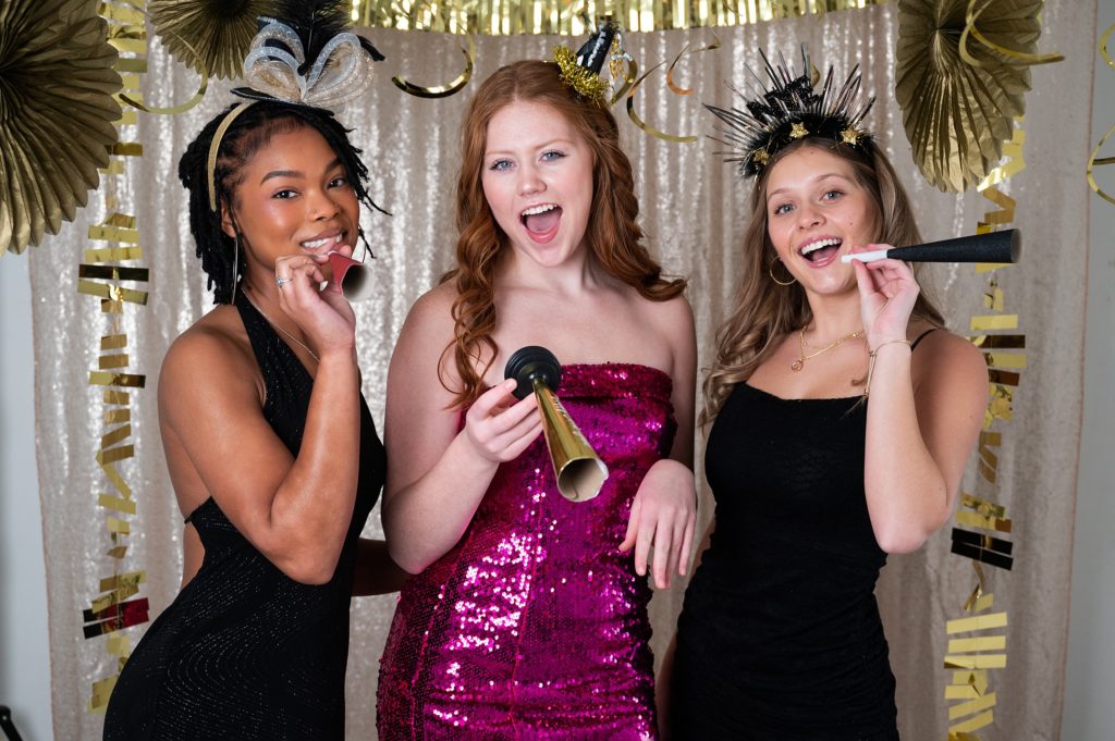 NYE themed styled photoshoot girls in sparkly dresses gold background