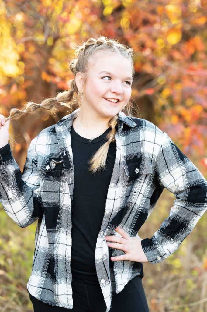 girl in black flannel shirt fall leaves 