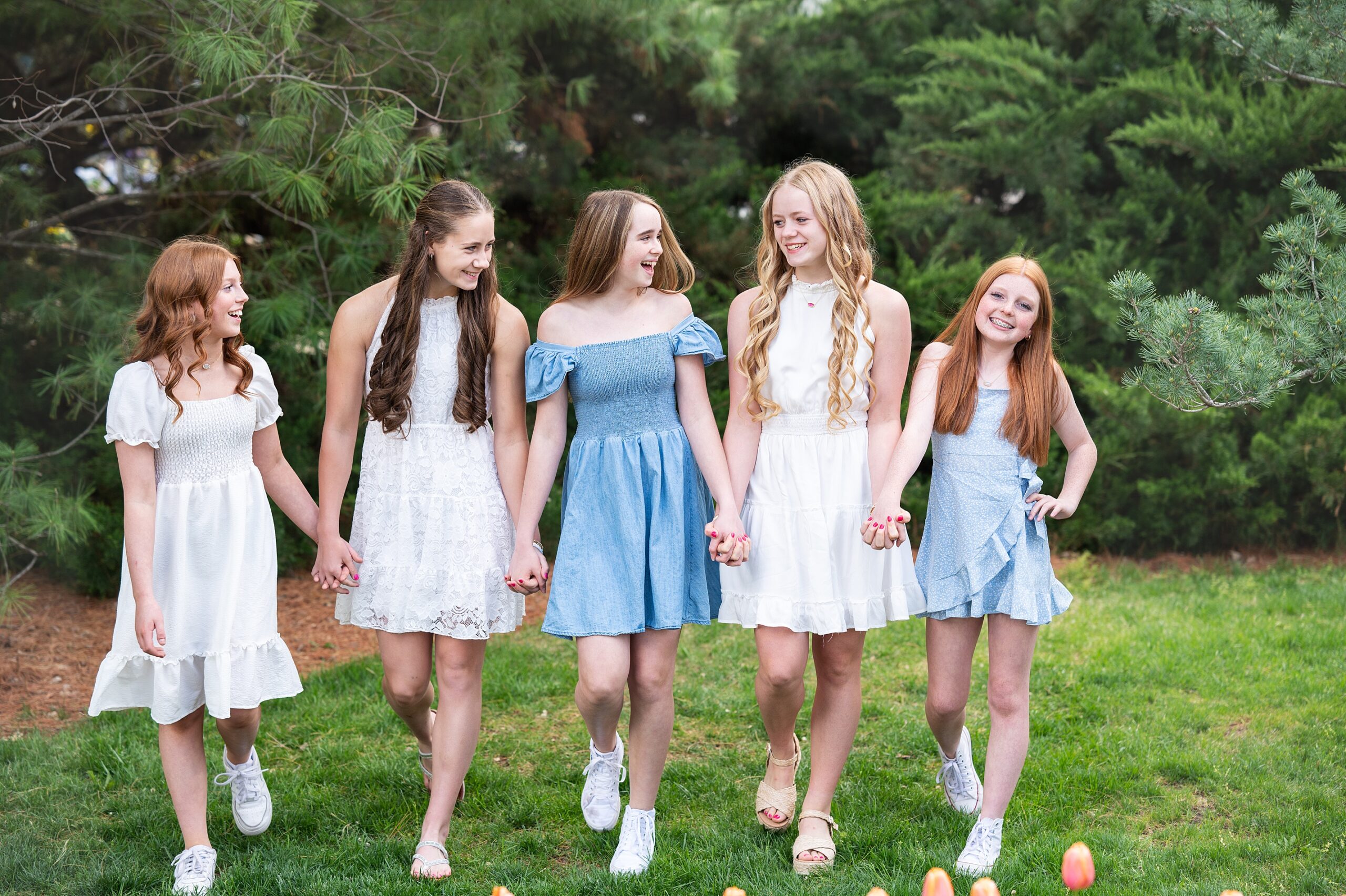 teen girls photoshoot in the spring wearing dresses in a natural setting
