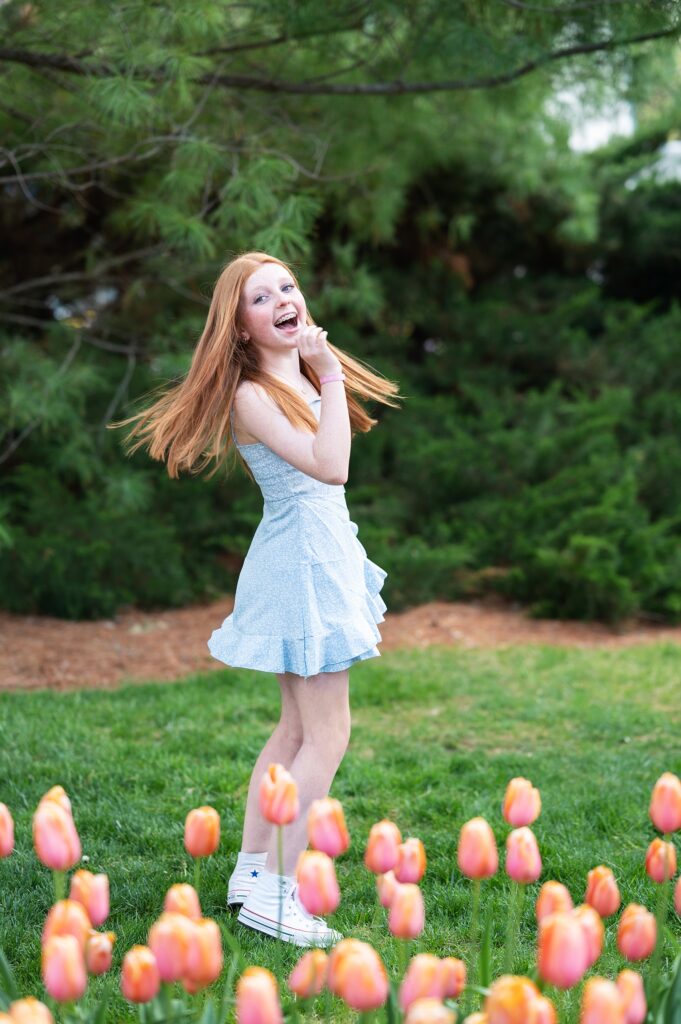 girl in blue dress in spring flowers photoshoot