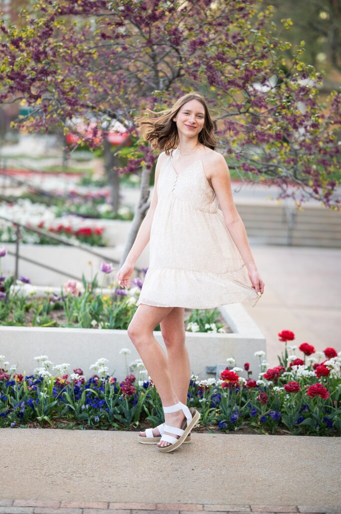 spring senior pictures tulips and flowering trees girl in white dress